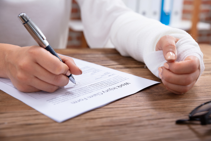 Injured Woman Filling Work Injury Claim Form Concerns about fraudulent FMLA