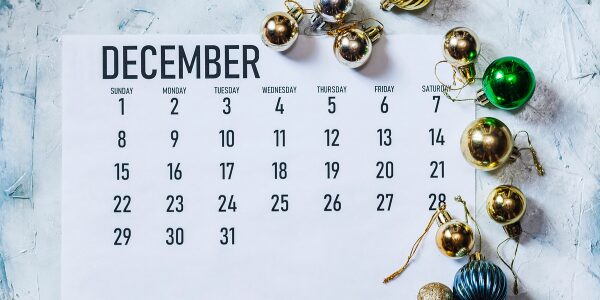 december 2024 calendar surrounded by Christmas tree decorations